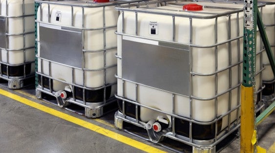 Industrial Workers Handling Chemical Waste Safely for Recycling in Houston, TX
