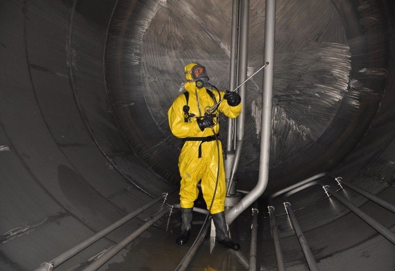 Worker Cleaning a Large Industrial Process Tank in Houston, TX