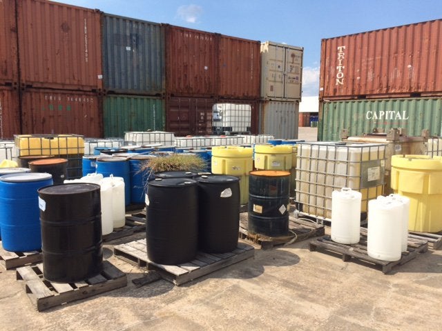 Workers in Safety Gear Handling Chemical Waste for Trading at Excel Industrial Group in Houston, TX