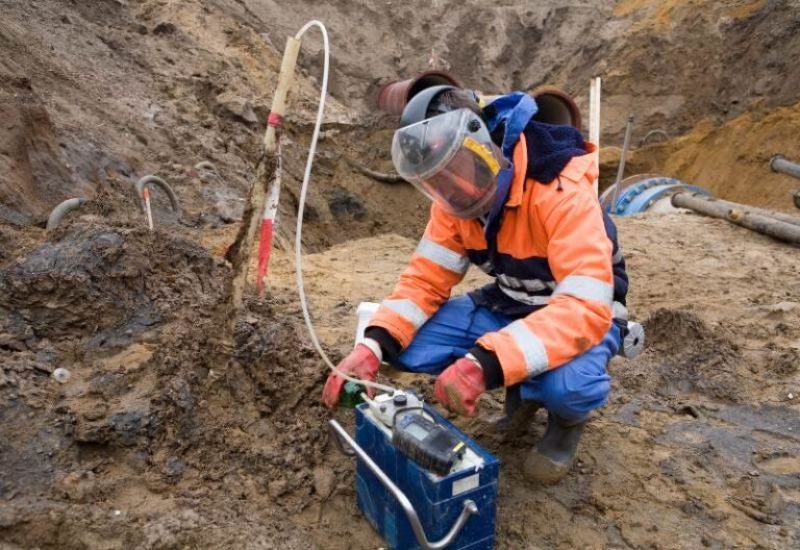 Workers in Safety Gear Examining Soil for Onsite Solutions in Houston, TX