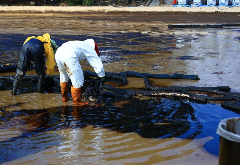 Workers in Protective Suits Cleaning Up a Contamination Spill in Houston, Texas