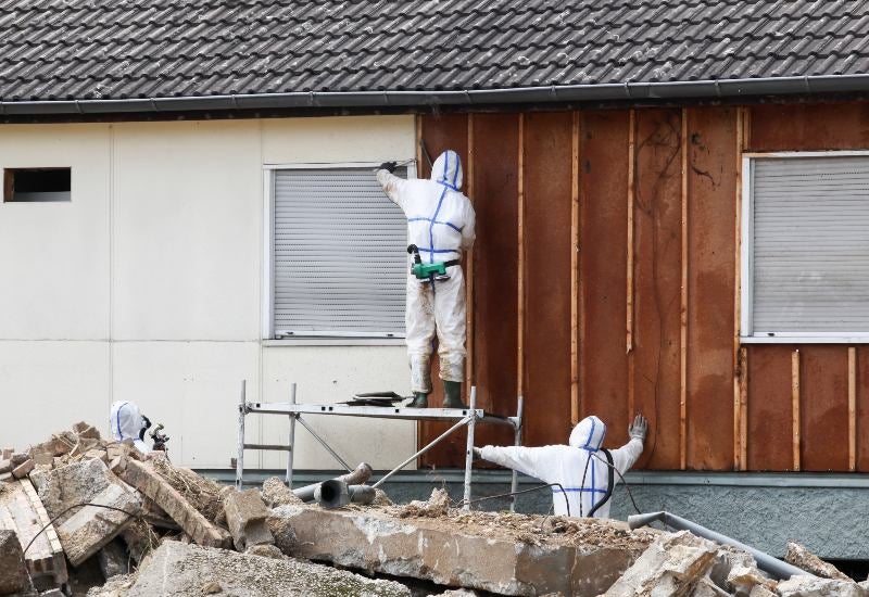 Professionals in Safety Gear Removing Asbestos in Houston, TX