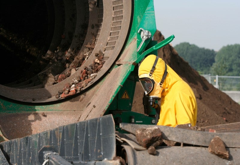 Workers in Safety Gear Performing Soil Remediation at an Industrial Site in Houston, TX