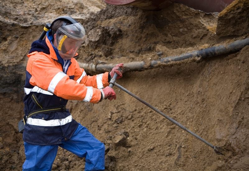 Worker Using Heavy Machinery for Soil Excavation at Excel Industrial Group in Houston, TX
