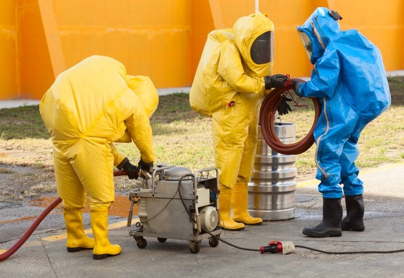 Workers in Protective Suits Removing Toxic Waste in Houston, TX