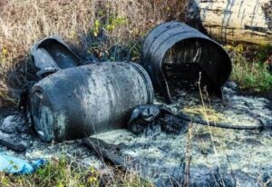 Drums Containing Chemical Spilled in a Grassy Area in Houston, TX