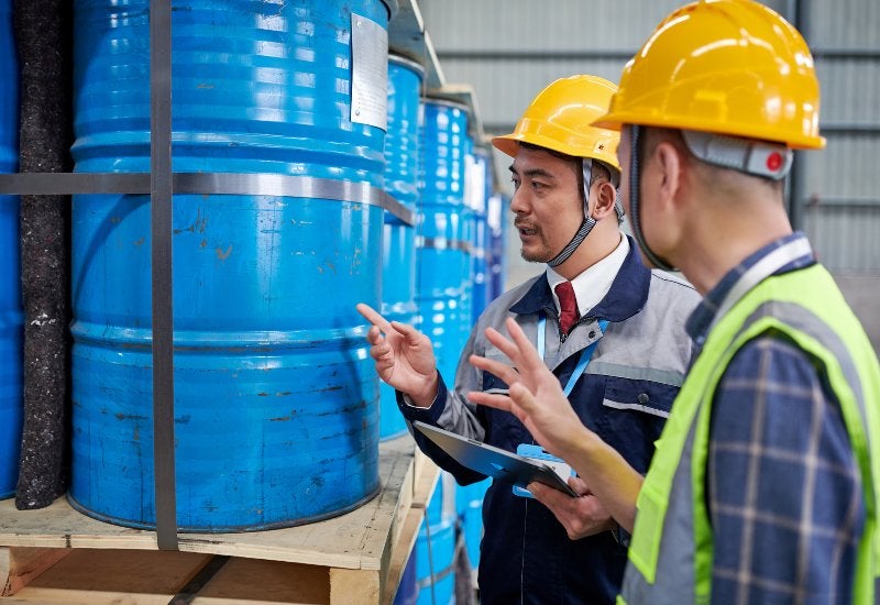 Workers in Safety Gear Handling Chemical Waste for Trading at Excel Industrial Group in Houston, TX